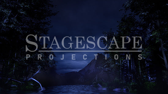 3D-rendered lakeside scenic projection backdrop for Swan Lake ballet, featuring gothic ruin, framed trees and distant mountains.