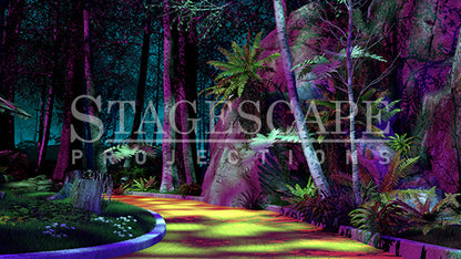 On the Yellow Brick Road scenic projection backdrop for The Wizard of Oz - Yellow Brick Road curving into the Wild Forest, dramatic cliff face with cascading ferns, white birch trees and deep forest canopy. StageScape Projections.