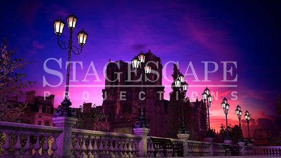 Paris Riverside Promenade static scenic projection backdrop for & Juliet — oil lamps along the Seine with Notre Dame in the distance. Five lighting states from dusk to night. StageScape Projections.