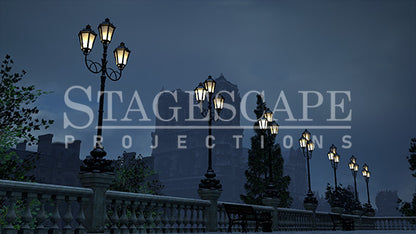 Paris Riverside Promenade static scenic projection backdrop for & Juliet — oil lamps along the Seine with Notre Dame in the distance. Five lighting states from dusk to night. StageScape Projections.